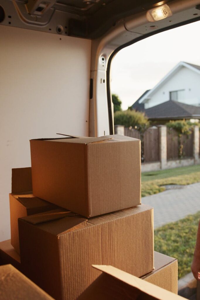 View inside a delivery van with stacked cardboard boxes ready for moving.